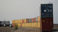 Arizona has resumed placing shipping containers along the Mexican border in places where there are gaps between border walls.